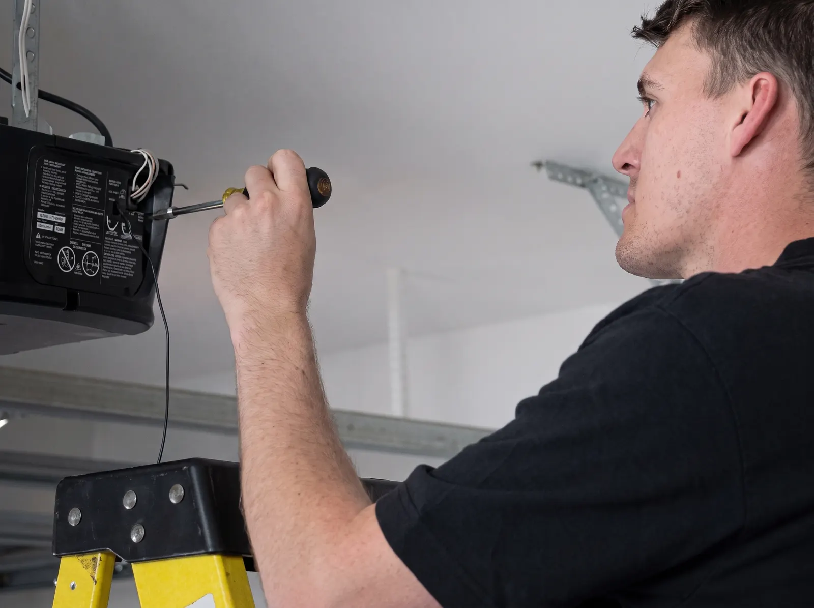 Technician repairing a garage door opener