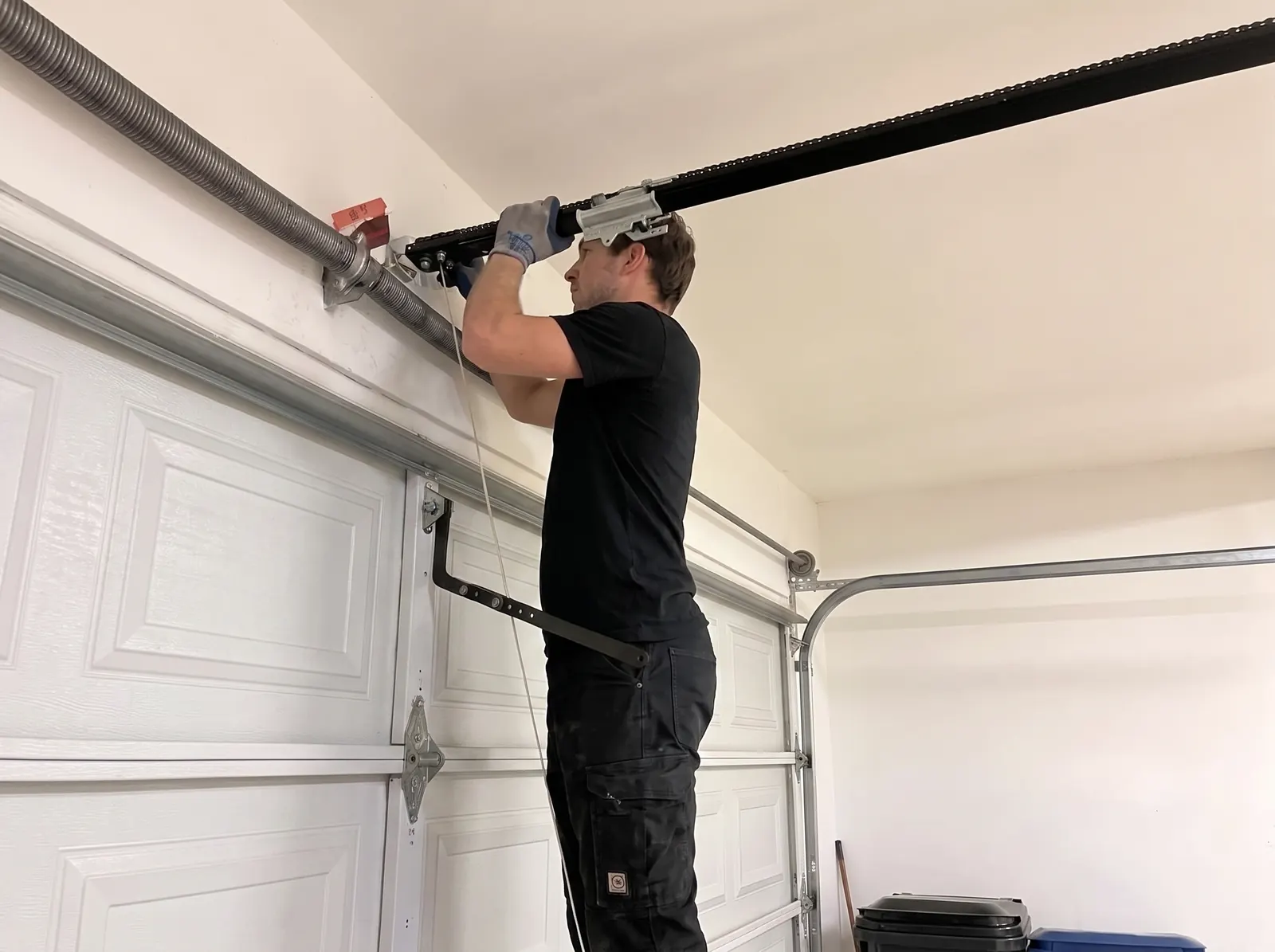 Technician repairing a garage door